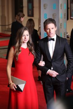 UK, London: British actor Eddie Redmayne and wife Hannah Bagshawe pose on the red Carpet at the EE British Academy Film Awards, BAFTA Awards, at the Royal Opera House in London, England, on 14 February 2016. 