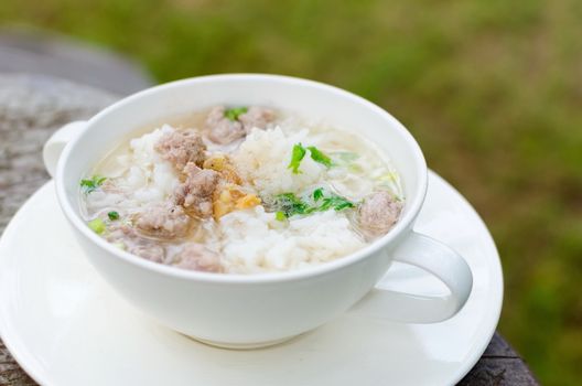 Boiled rice with pork in white  bowl. Thailand is a popular breakfast.