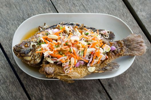 Deep fried red tilapia with herb and spicy sauce, Thai food