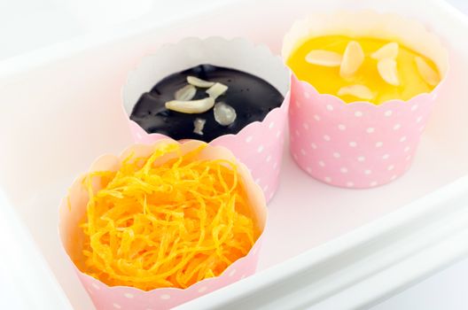 Cupcakes, flavor sweet egg,orange , chocolate isolated on white background.