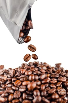 Roasted coffee beans pouring out from the pack.