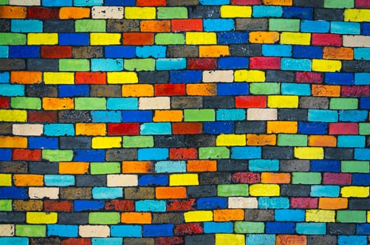 Colorful brick wall - beautiful variety colors red green yellow blue cement pattern background
