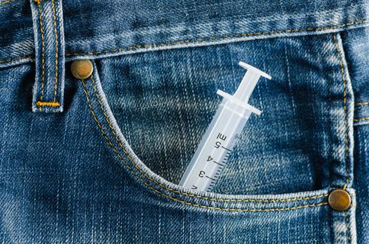 Syringe in the pocket of a blue jeans