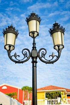 Vintage street lamp post on blue sky