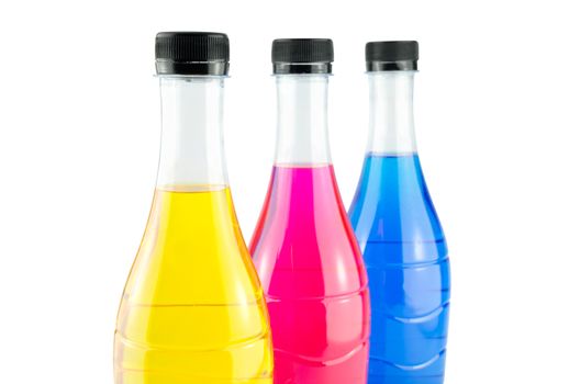 Bright colorful water in bottles on white background