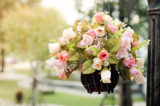 vintage style. Hanging basket of artificial flowers.