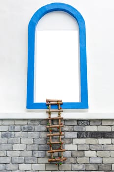 window with white copyspace and rope ladder on wall.