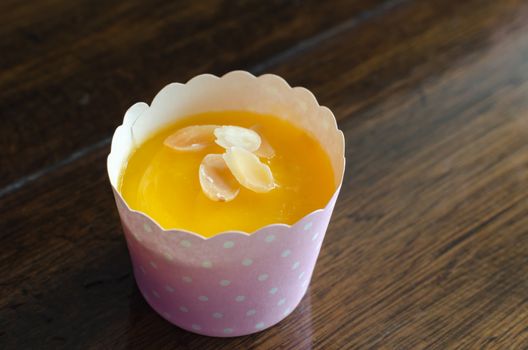 Cupcakes and sweet orange flavor on wood table.