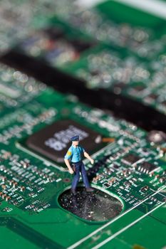 Macro picture of computer electronics with a policeman