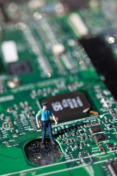 Macro picture of computer electronics with a policeman