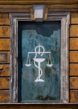 Old pharmacy advertisement on a facade of a house.