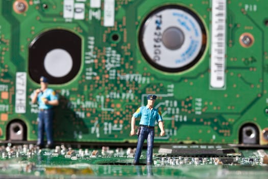 Macro picture of computer electronics with a policeman