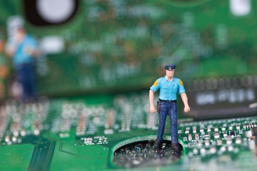 Macro picture of computer electronics with a policeman