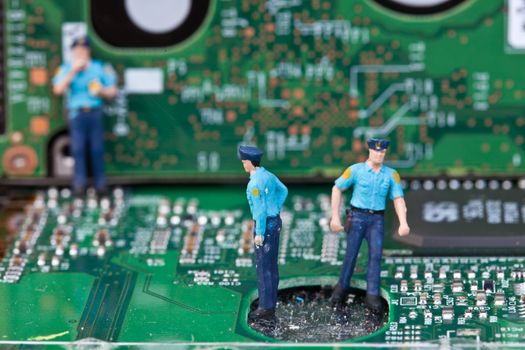 Macro picture of computer electronics with a policeman