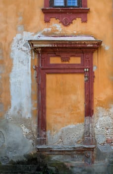 Old walls of an abandoned manor-house. Decorative window.