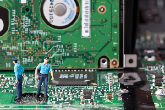 Macro picture of computer electronics with a policeman