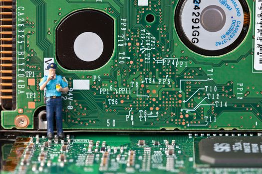 Macro picture of computer electronics with a policeman