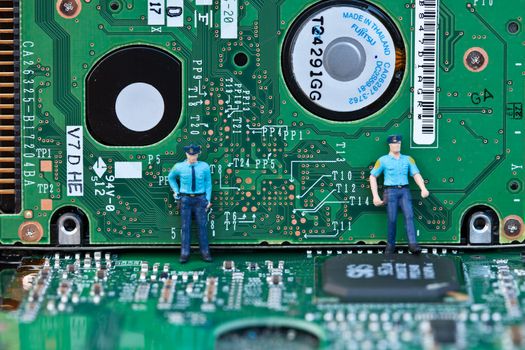 Macro picture of computer electronics with a policeman