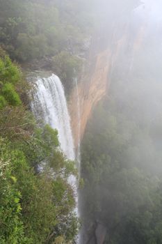 Standing in the clouds  high at the top of the Fitzroy Falls, which drop over 80 metres to the valley below.   Fitzory Falls is located in Wingecarribee Shire,  Southern Highlands, 