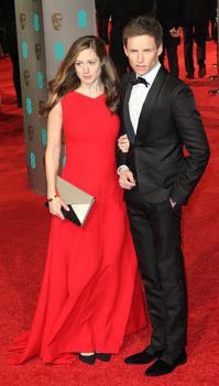 UK, London: British asctor Eddie Redmayne poses with wife Hannah Bagshawe on the red Carpet at the EE British Academy Film Awards, BAFTA Awards, at the Royal Opera House in London, England, on 14 February 2016.