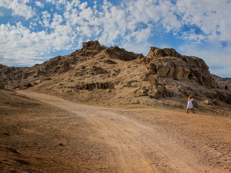 Landscape in the desert in Egypt. Rocky hills. Blue sky with many white clouds.