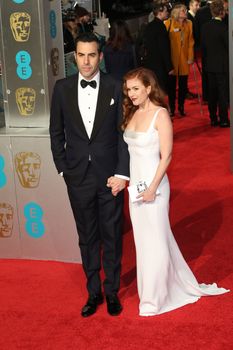 UK, London: Australian actress Isla Fisher poses with husband Sacha Baron Cohen on the red Carpet at the EE British Academy Film Awards, BAFTA Awards, at the Royal Opera House in London, England, on 14 February 2016.