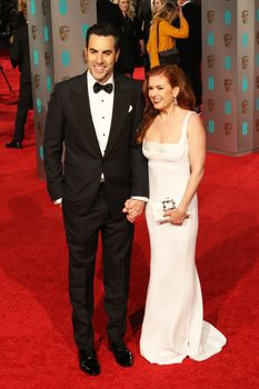 UK, London: Australian actress Isla Fisher poses with husband Sacha Baron Cohen on the red Carpet at the EE British Academy Film Awards, BAFTA Awards, at the Royal Opera House in London, England, on 14 February 2016.