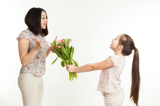 the girl gives to mother a bouquet of flowers