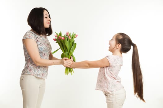 the girl gives to mother a bouquet of flowers