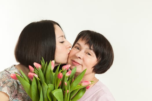 the woman presented a bouquet of flowers for mother and kisses it