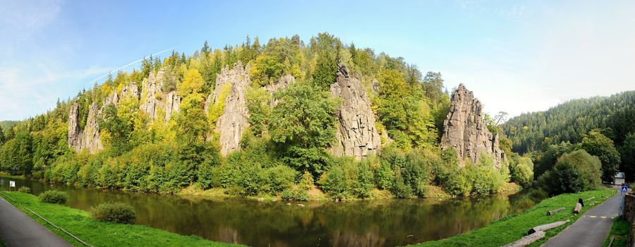 Rocks enlightened sun on a lazy river in Bohemia