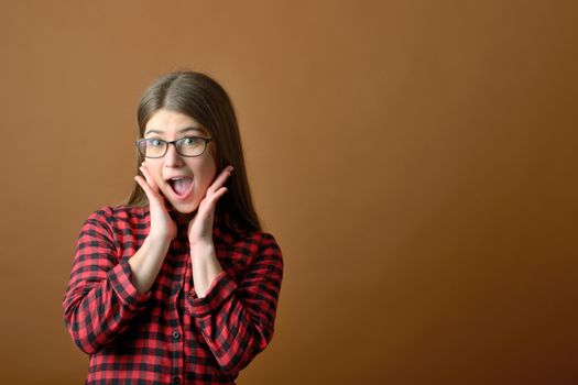 Surprised happy teen girl in studio