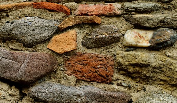 Background of Various Big Colored Cracked Stones with Concrete closeup