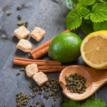 tea composition with cinnamon sticks, lemons