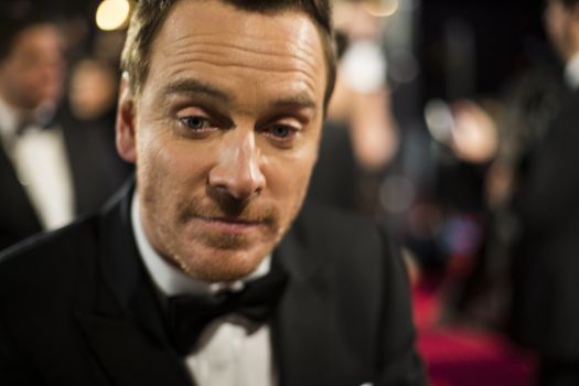 ENGLAND, London: Michael Fassbender walks on the red carpet going to the BAFTA's on February 14, 2016 in London.
