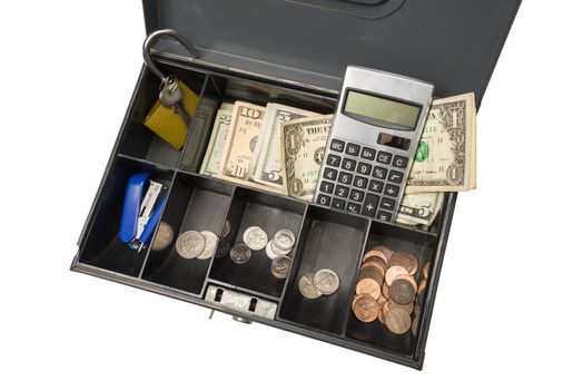 Old cash box at an angle containing cash, coins, a calculator, and a stapler.