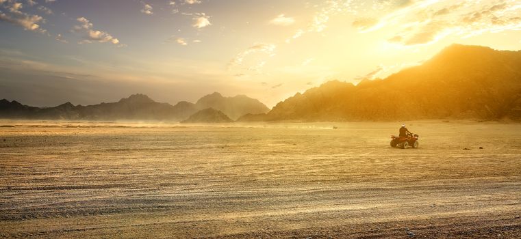 Sandy field in desert of Egypt at sunset