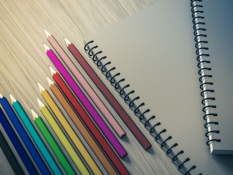 color pencil on checked notebook on wood background, stationary object