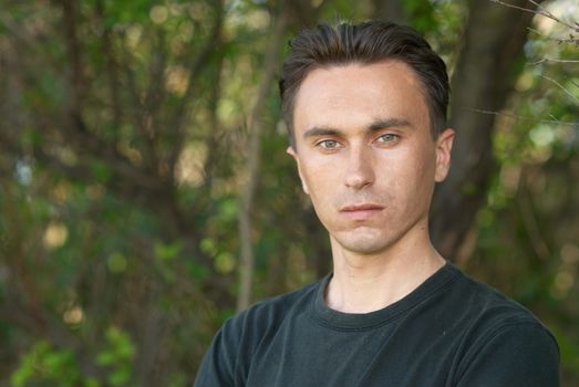 Man's portrait in the soft forest background