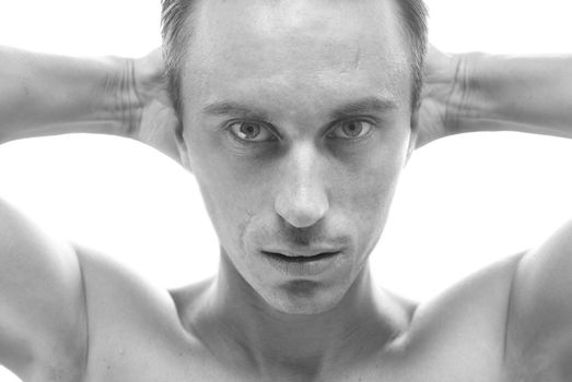 Black-and-white portrait of muscular man isolated on white