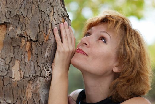 Beautiful woman near tree, with soft background