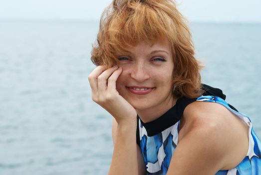 Close portrait of beautiful woman with blue background