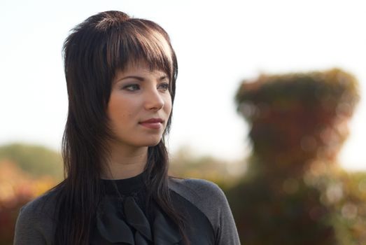 Beautiful girl's portrait with soft outdoor background