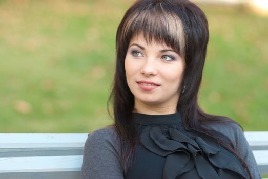 Portrait of beautiful girl sitting on the bench