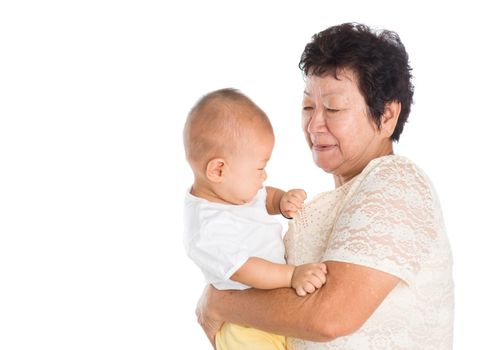 Asian grandmother taking care grandchild, isolated on white background.