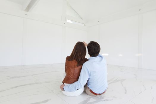 Couple sitting in new house and dreaming about future