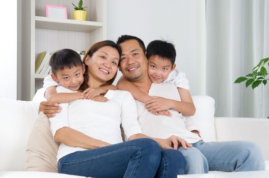 Portrait of asian family sitting on sofa