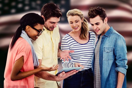 Happy creative team using a tablet pc against composite image of digitally generated united states national flag