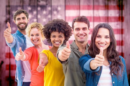 Group portrait of happy young colleagues against composite image of usa national flag