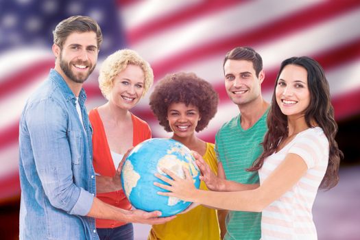 Young creative business people with a globe  against composite image of digitally generated united states national flag